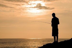 A Young Man Fishing In Hawaii at Sunset